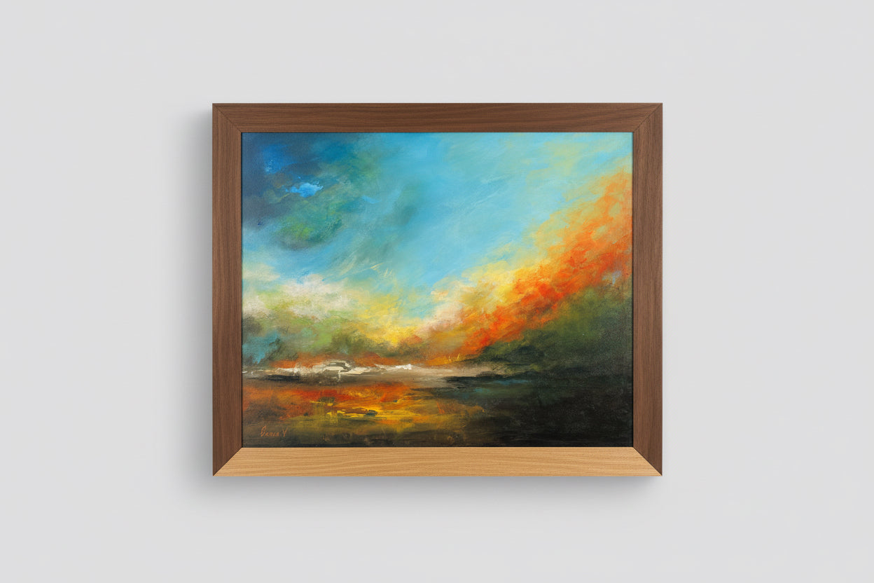 Framed painting of a colorful sky over water on a wall.
