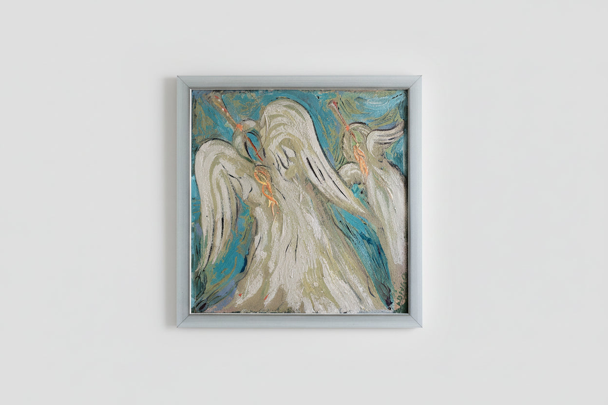 A framed artwork featuring an angel in a stained glass style, with a blue and white color palette, displayed on a wall.