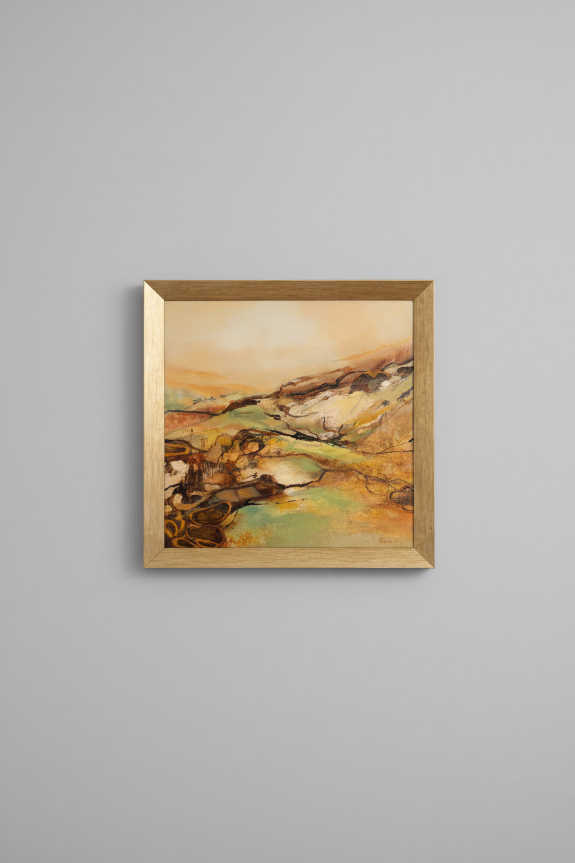 Abstract painting in a gold frame on a gray wall